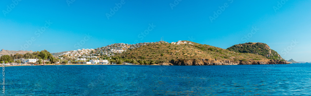 Panoramic View of Aegean sea, traditional white houses, marina, sailing boats and yachts in Bodrum city of Turkey. Aegean style turquoise water in Bodrum town Turkey.