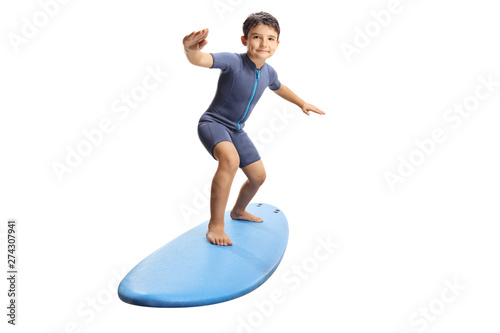 Little boy surfing on a surfboard