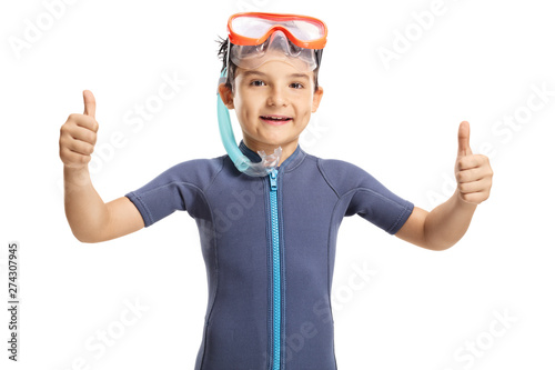 Smiling little boy with a snorkeling mask showing thumbs up