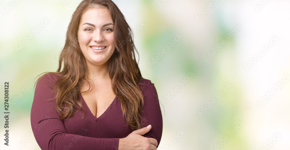 Naklejka premium Beautiful and attractive plus size young woman wearing a dress over isolated background happy face smiling with crossed arms looking at the camera. Positive person.