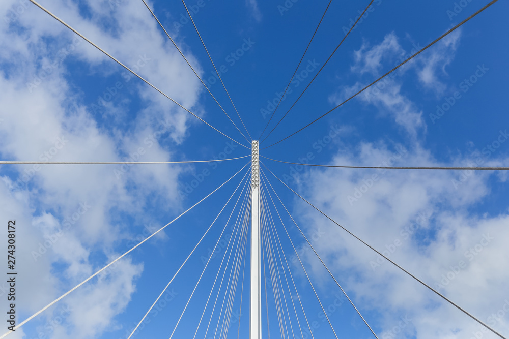 perspective of one tower and vertical suspender cables of a hanging bridge perspective of one tower and vertical suspender cables of a hanging bridge