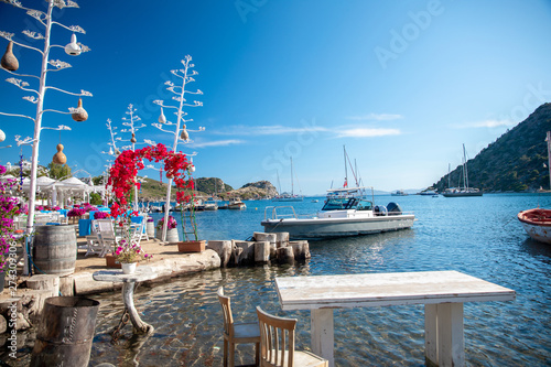 Fototapeta Naklejka Na Ścianę i Meble -  View of the Gumusluk, Bodrum Marina, sailing boats and yachts in Bodrum town, city of Turkey. Shore and coast of Aegean Sea with yachts and boats