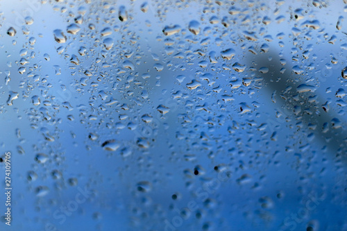 rain water drops on glass window blurred background selective focus close up