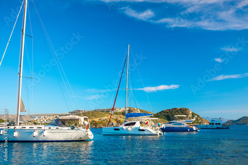 View of the Gumusluk, Bodrum Marina, sailing boats and yachts in Bodrum town, city of Turkey. Shore and coast of Aegean Sea with yachts and boats © Hakan Tanak