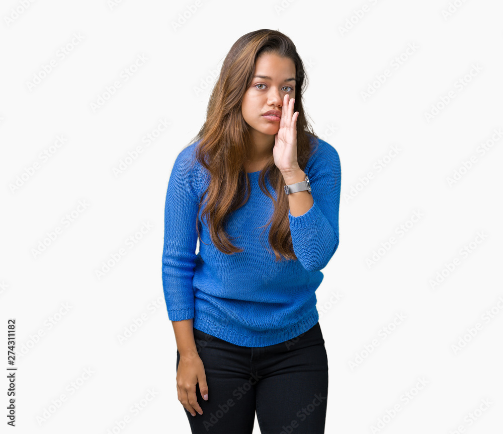 Young beautiful brunette woman wearing blue sweater over isolated background hand on mouth telling secret rumor, whispering malicious talk conversation Young beautiful brunette woman wearing blue sweater over isolated background hand on mouth telling secret rumor, whispering malicious talk conversation