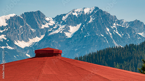 Beautiful alpine view with details of a red roof at Hohe Salve summit - Söll - Tyrol - Austria