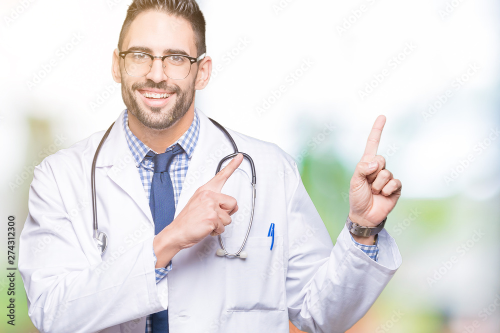 Handsome young doctor man over isolated background smiling and looking at the camera pointing with two hands and fingers to the side. Handsome young doctor man over isolated background smiling and looking at the camera pointing with two hands and fingers to the side.
