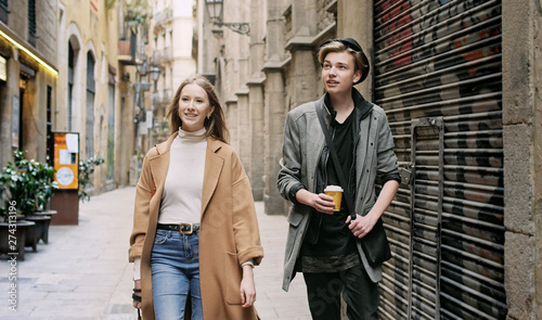 Photography Friends walking together through tight street.