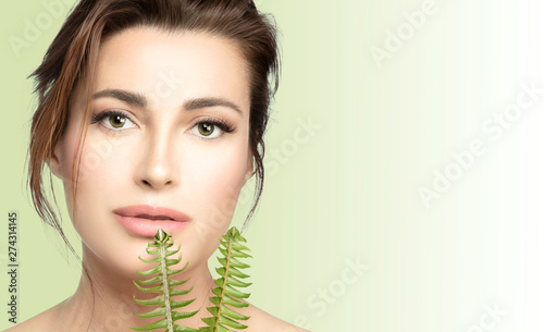 Natural skincare. Beauty Spa Woman with Fresh green leaves. Health and spa treatment concept