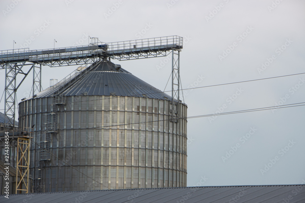 Elevator, huge container of the granary against the background of the blue sky