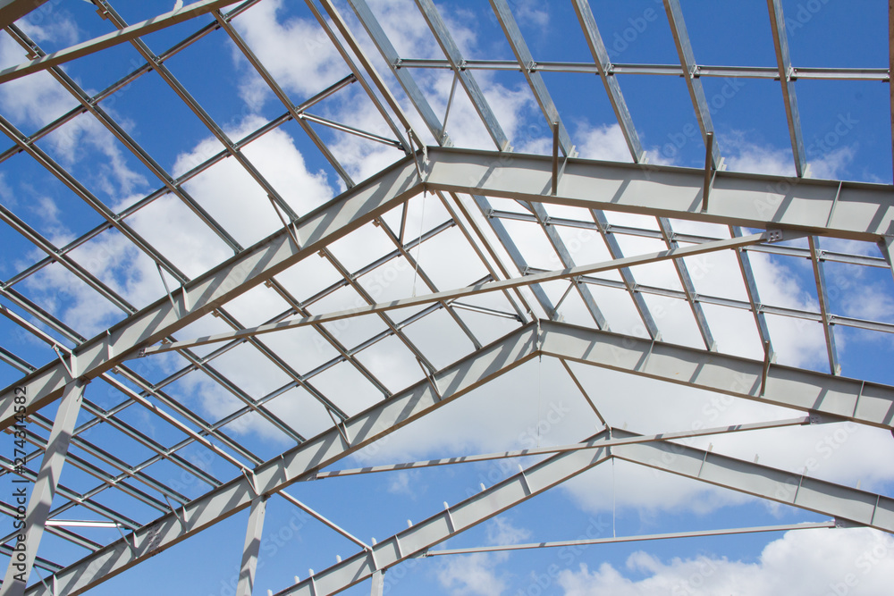 Naklejka premium The structure of the building. Steel construction on the sky background. Electroplate steel metal. Zinc metal coating to protect against corrosion.