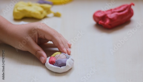 kids playing with play dough over white background