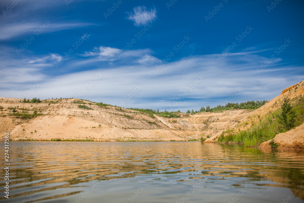 Landscape with lake and mountains in the sand quarry