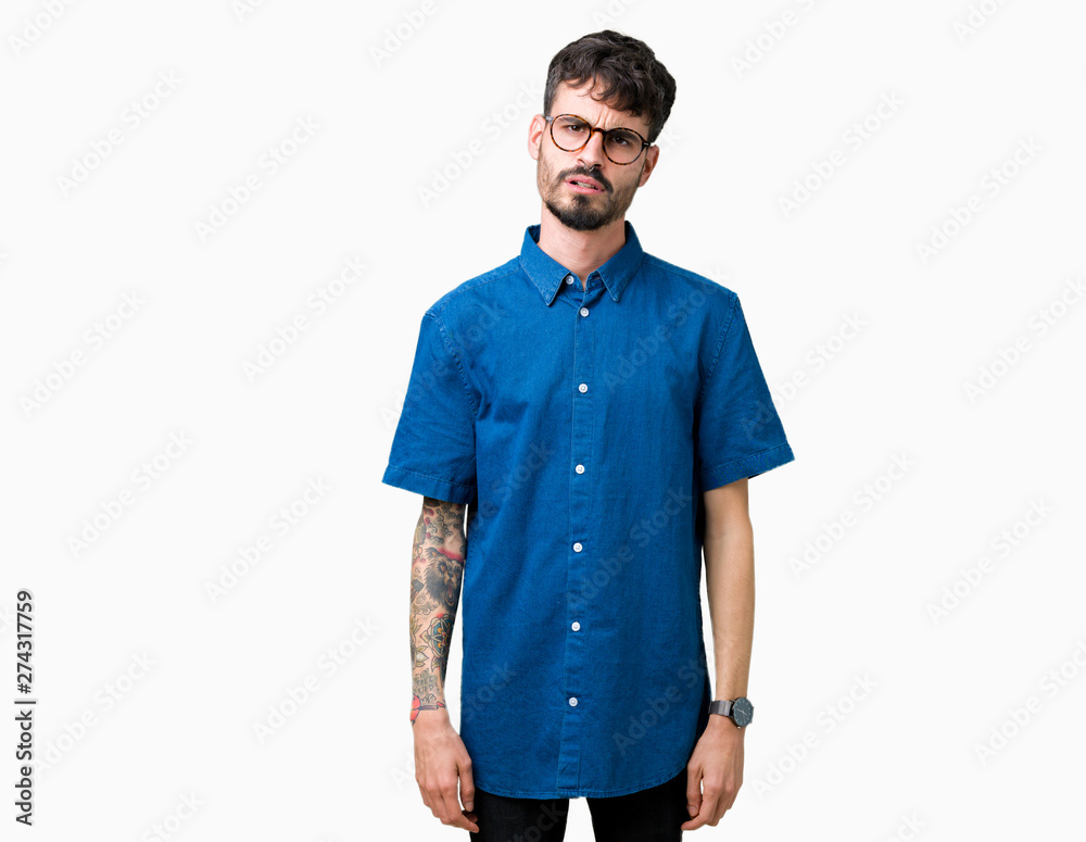 Young handsome man wearing glasses over isolated background In shock face, looking skeptical and sarcastic, surprised with open mouth Young handsome man wearing glasses over isolated background In shock face, looking skeptical and sarcastic, surprised with open mouth