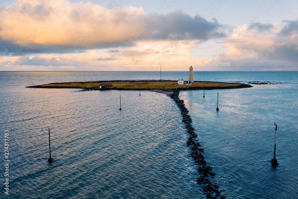 Stones running to island with tower between sea Stones running to island with tower between sea