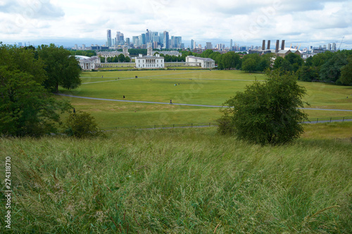 LONDON, ENGLAND/UNITES KINGDOM –– JUNE 11 2019: View of London from Greenwich park at cloudy summer day