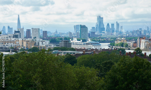 LONDON, ENGLAND/UNITES KINGDOM –– JUNE 11 2019: View of London from Greenwich park at cloudy summer day