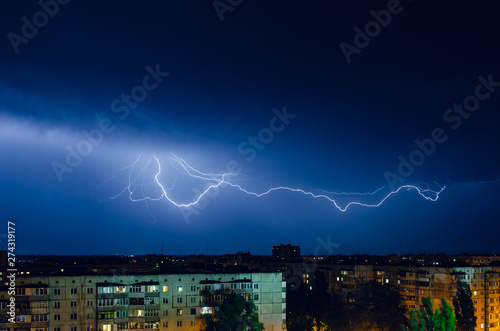 Thunderstorm with lightning and thunder over the night city