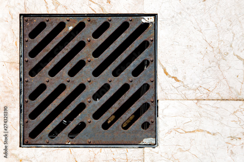 Wallpaper Mural storm shower iron grate on a pedestrian pavement of marble top view close up. Torontodigital.ca