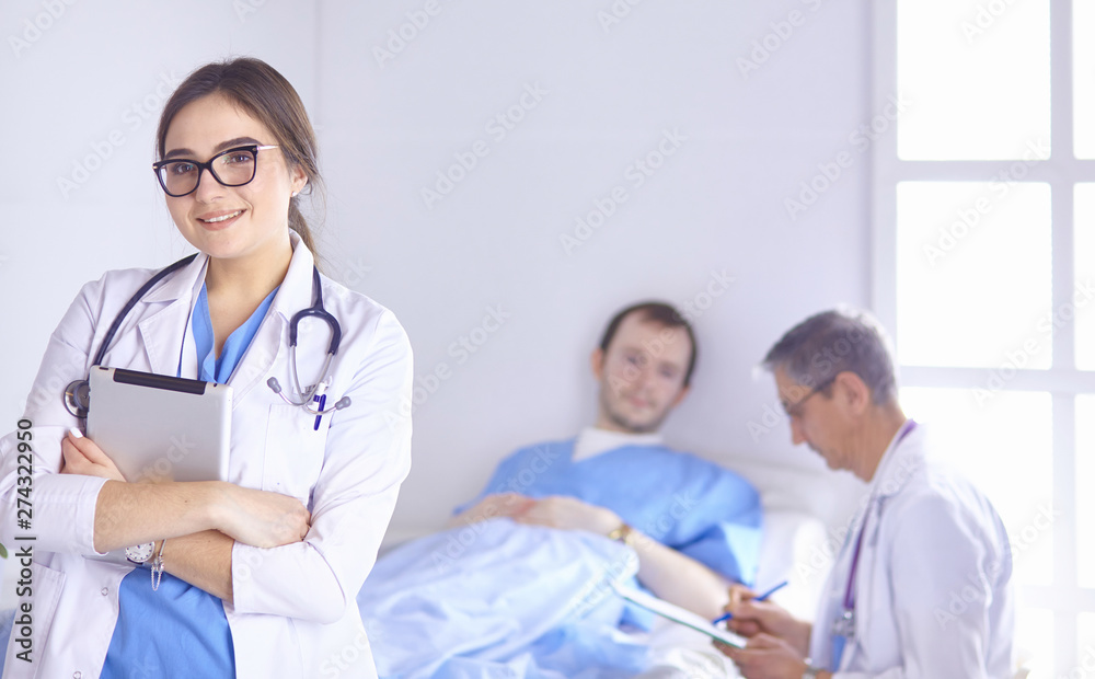 Doctor checking heart beat of patient in bed with stethoscope Doctor checking heart beat of patient in bed with stethoscope