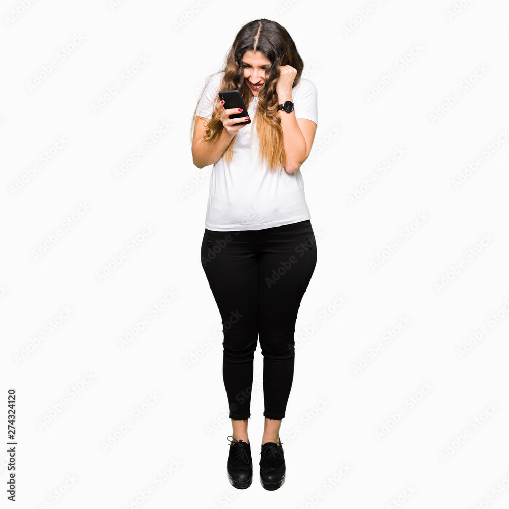 Young adult woman using smartphone screaming proud and celebrating victory and success very excited, cheering emotion Young adult woman using smartphone screaming proud and celebrating victory and success very excited, cheering emotion