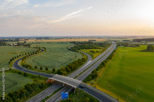 road and german highway or autobahn, agricultural fields and meadows