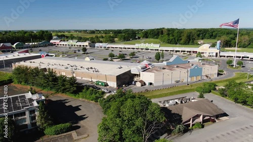 Aerial pull back from strip mall to reveal the vast space and building surrounding the area of the Tanger Outlet, Lancaster, Pennsylvania Concept: commerce, layout, investment