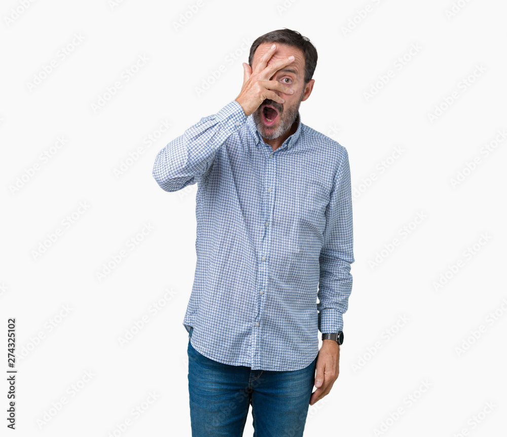 Handsome middle age elegant senior man over isolated background peeking in shock covering face and eyes with hand, looking through fingers with embarrassed expression. Handsome middle age elegant senior man over isolated background peeking in shock covering face and eyes with hand, looking through fingers with embarrassed expression.