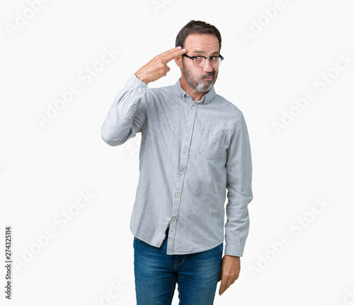 Handsome middle age elegant senior man wearing glasses over isolated background Shooting and killing oneself pointing hand and fingers to head, suicide gesture. © Krakenimages.com