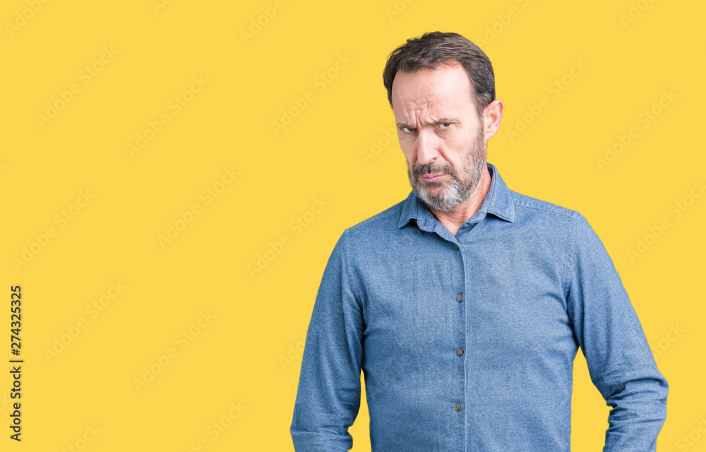 Fototapeta premium Handsome middle age elegant senior man over isolated background skeptic and nervous, frowning upset because of problem. Negative person.