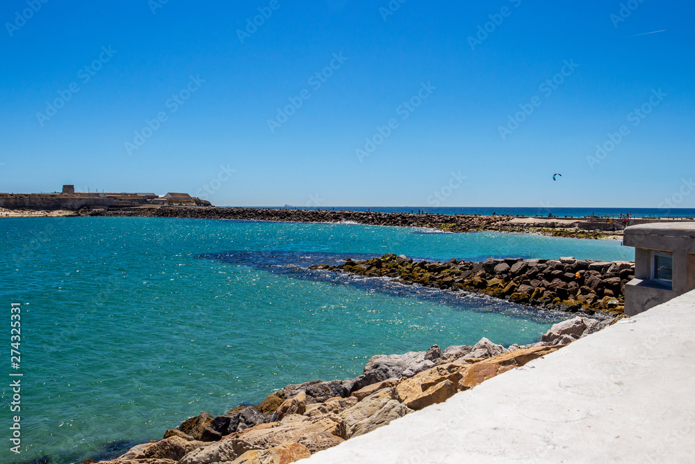 View from Tarifa, Andalusia Spain to Isla de las Palomas with stone breakwaters