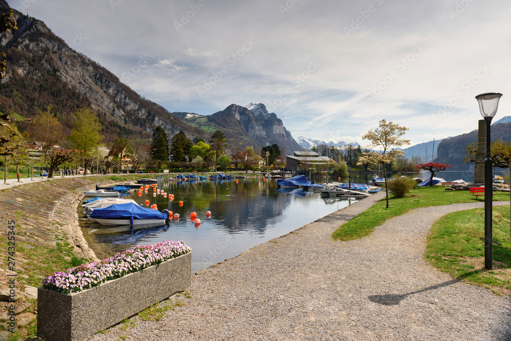 Naklejka premium View of the Walensee lake on a sunny spring day. Village of Weesen, Switzerland.
