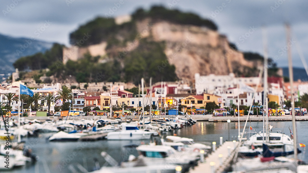 DENIA, SPAIN - JUNE 13, 2019: Panoramic view of Denia port promenade and castle.