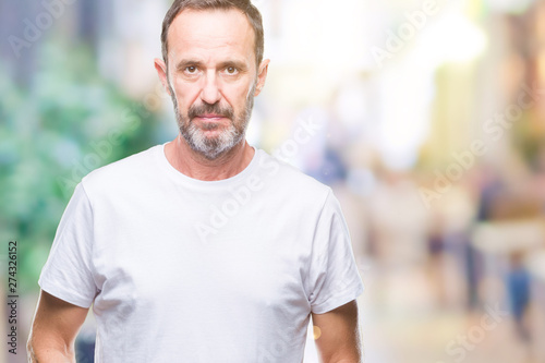 Middle age hoary senior man wearing white t-shirt over isolated background with serious expression on face. Simple and natural looking at the camera.