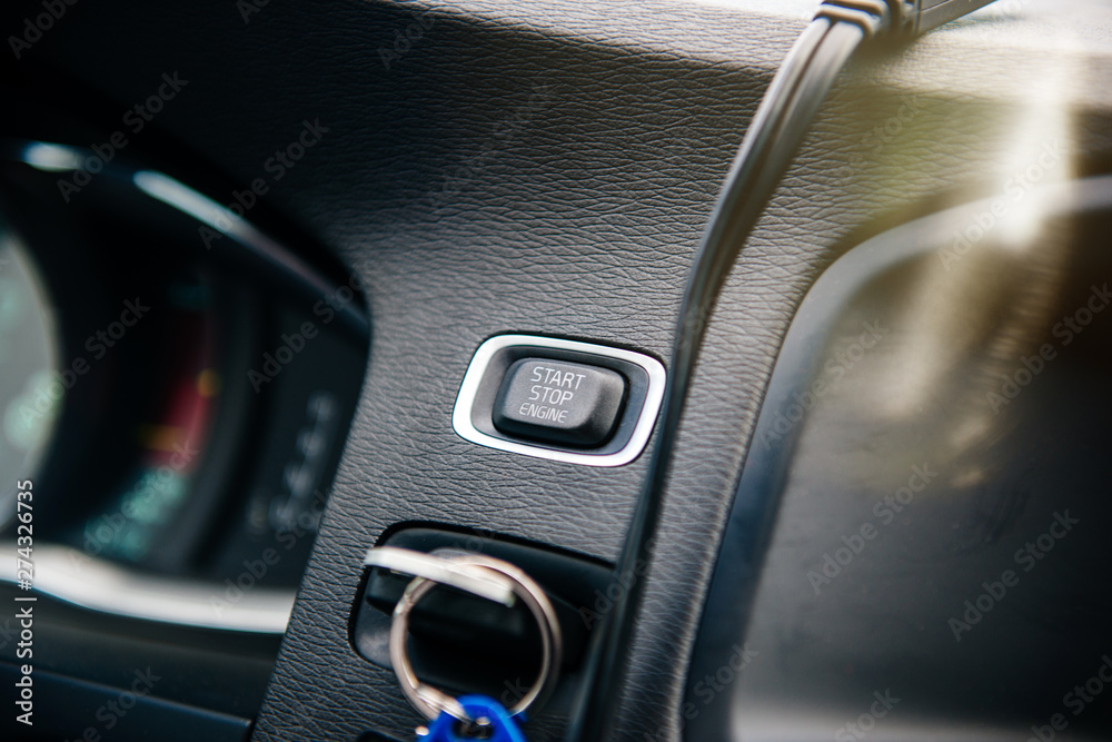 Close-up on the Start Stop engine button inside modern luxury car