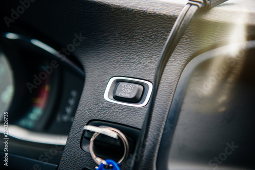 Close-up on the Start Stop engine button inside modern luxury car © ifeelstock