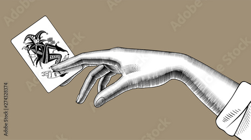 Female hand holding Joker playing card