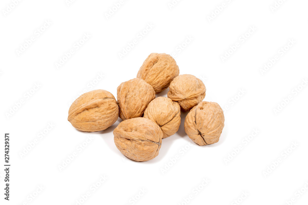 Raw walnuts in shell isolated on white background. Raw walnuts in shell isolated on white background.
