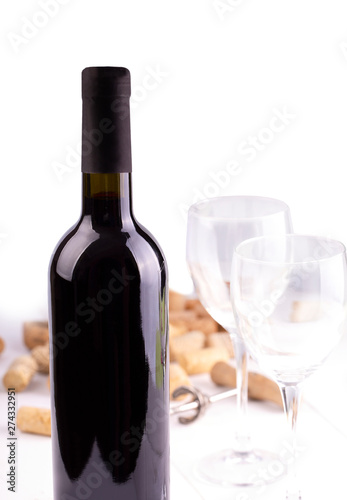 The Red wine glasses, bottle and corks. Isolated on white background