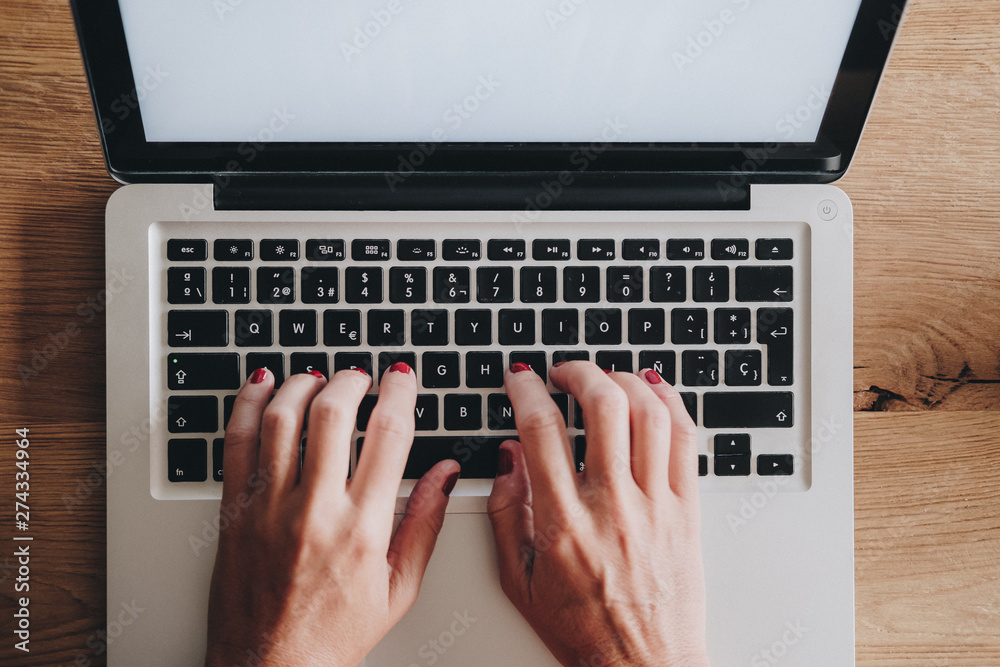 Woman using laptop with cup of coffee Woman using laptop with cup of coffee