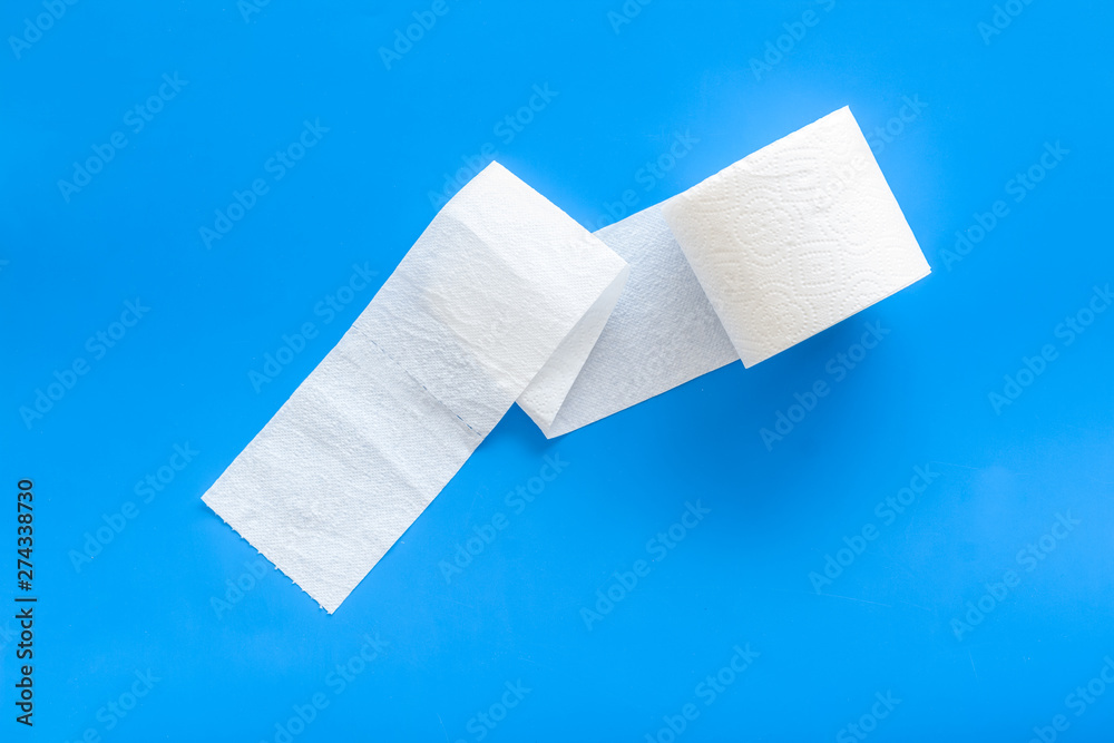 Toilet paper roll on blue background top view Toilet paper roll on blue background top view