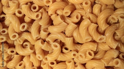 Dry elbow macaroni Italian pasta closeup cooked