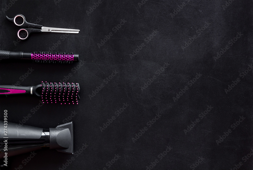 Hairdresser equipment for cutting hair and styling with combs, sciccors, brushes on black background top view copyspace Hairdresser equipment for cutting hair and styling with combs, sciccors, brushes on black background top view copyspace