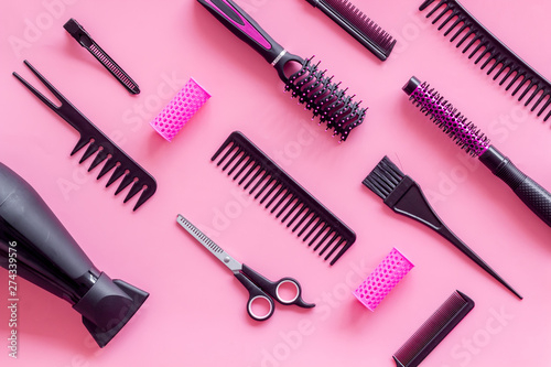Hairdresser equipment for cutting hair and styling with combs, sciccors, brushes on pink background top view pattern
