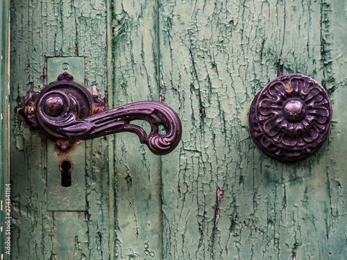 Closeup of the doorknob on the old green door