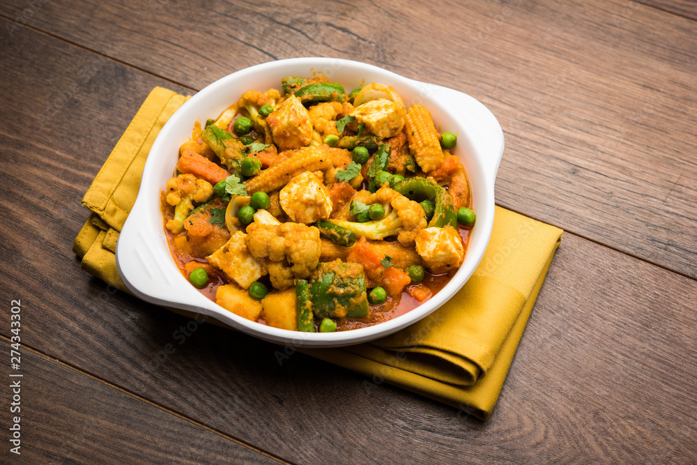 Mix vegetable curry - Indian main course recipe contains Carrots, cauliflower, green peas and beans, baby corn, capsicum and paneer/cottage cheese with traditional masala and curry, selective focus