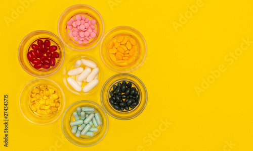 Group of several sizes of pills in glass