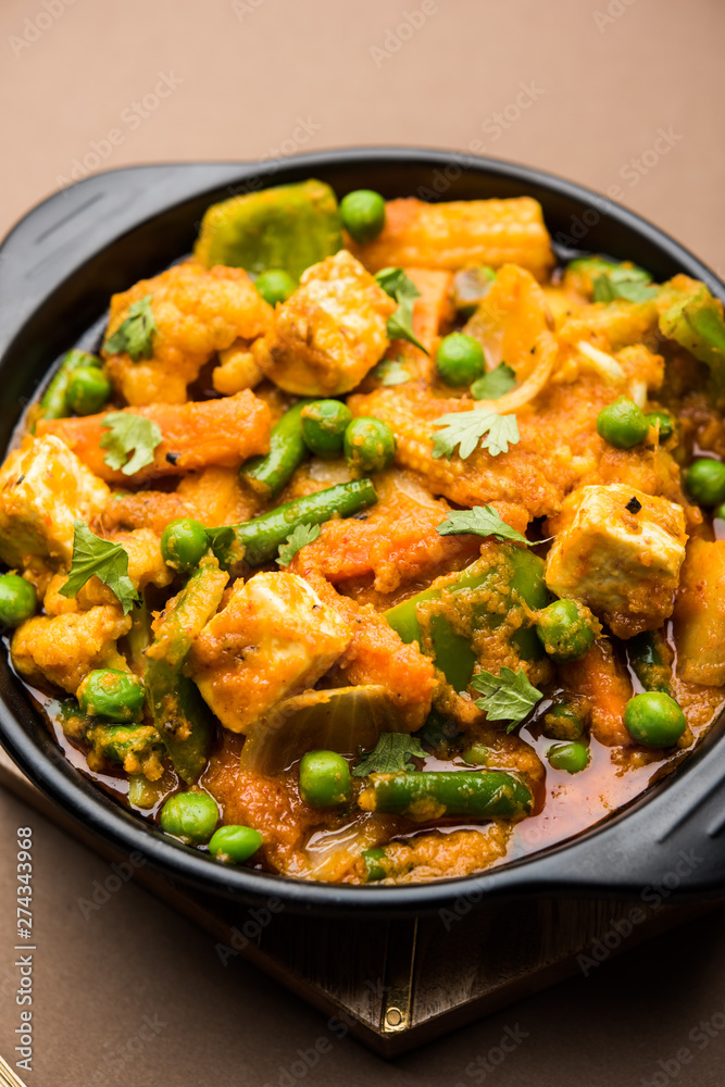 Mix vegetable curry - Indian main course recipe contains Carrots, cauliflower, green peas and beans, baby corn, capsicum and paneer/cottage cheese with traditional masala and curry, selective focus Mix vegetable curry - Indian main course recipe contains Carrots, cauliflower, green peas and beans, baby corn, capsicum and paneer/cottage cheese with traditional masala and curry, selective focus