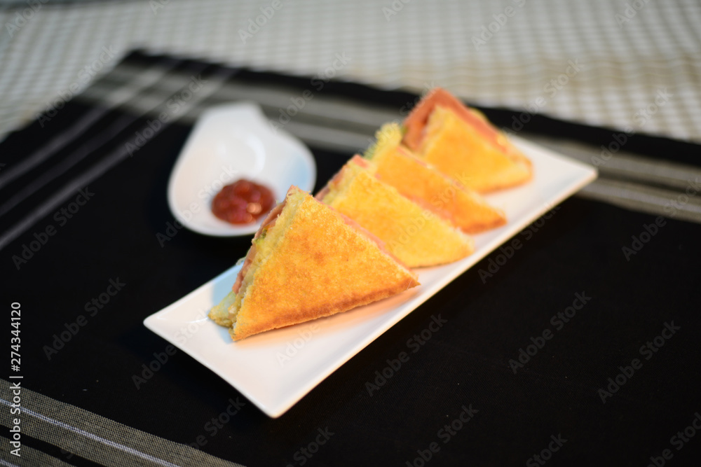 ham and cheese toasted sandwich, setup nicely on table ready to serve ham and cheese toasted sandwich, setup nicely on table ready to serve