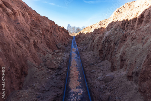 Plastic water pipe lay in a trench